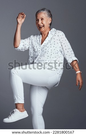 Im always ready for some action. Studio shot of a senior woman posing against a grey background.