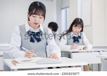 High school students concentrating and taking notes Royalty-Free Stock Photo #2281825877