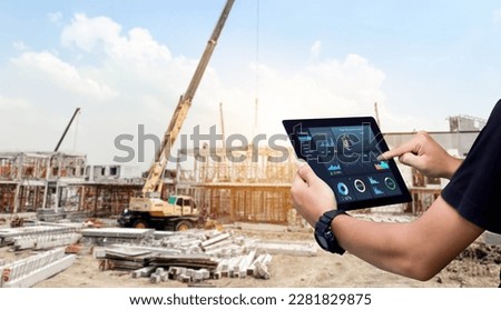 Smart Construction Project management system concept.Hands using digital tablet with Construction Management Software on blurred construction site as background