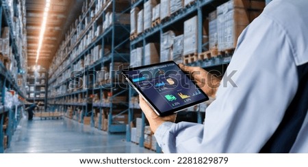 Smart Warehouse,Inventory management system concept.Manager using digital tablet,showing warehouse software management dashboard on blurred warehouse as background Royalty-Free Stock Photo #2281829879