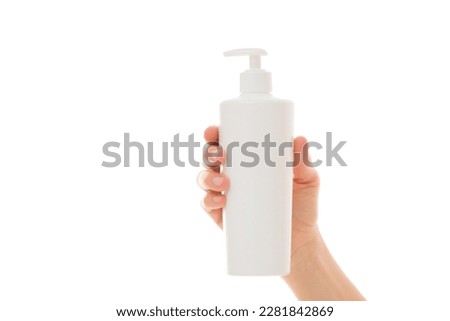 Young adult woman hand holding big plastic pump bottle isolated on white background. Care about clean and soft body skin. Daily beauty product. Closeup. Front view. Royalty-Free Stock Photo #2281842869