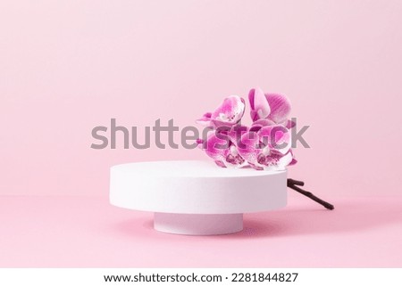 White round podium pedestal cosmetic beauty product goods branding design presentation empty mockup on light pink background with shadows and beautiful pink orchid flowers  cosmetic mockup Royalty-Free Stock Photo #2281844827