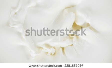Freeze motion of whirling milk cream, close-up Royalty-Free Stock Photo #2281853059