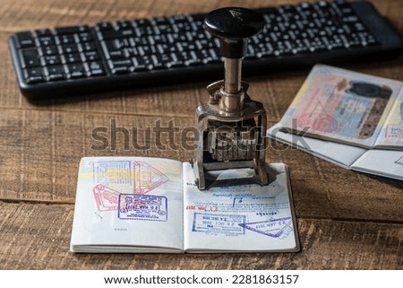 Immigration and passport control at the airport. Border control a stamp in the international passport, close up. Vacation and travel concept