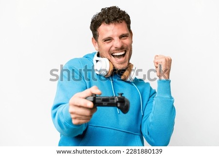 Brazilian man playing with a video game controller over isolated white background