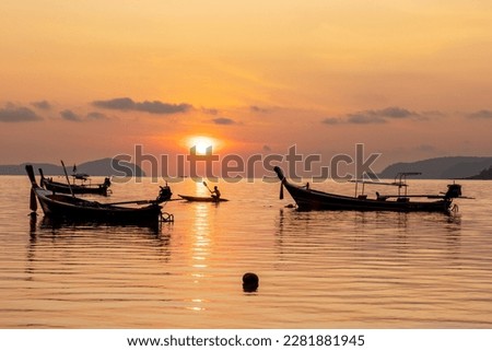 Magical sun setting on the beach of Rawai on the island of Phuket in Thailand.