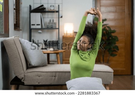 Young calm black woman relaxing in modern living room, lazy happy african woman girl resting on couch breathing fresh air enjoy peace of mind no stress free on couch at home. Royalty-Free Stock Photo #2281883367