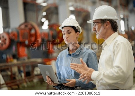A new generation of engineers in a metal sheet factory.  Studying work methods from supervisors or colleagues and studying by yourself  be taught professionally Royalty-Free Stock Photo #2281888611