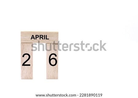 April 26 displayed wooden letter blocks on white background with space for print. Concept for calendar, reminder, date. 