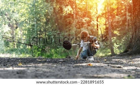 a boy with a metal detector walks in the woods. High quality photo
