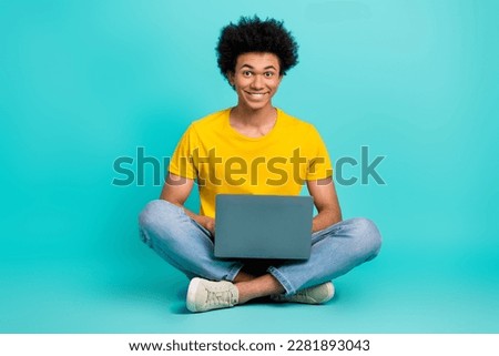Full body photo of positive cheerful person sit floor use wireless netbook isolated on turquoise color background