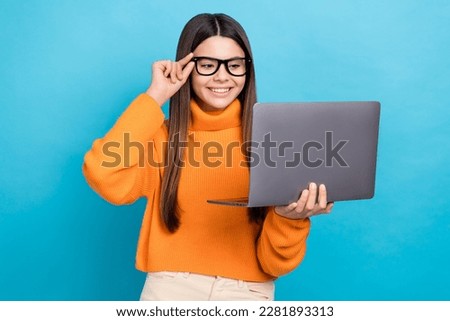 Photo of funny clever nice girl long hairstyle wear knit turtleneck touch glasses look at laptop isolated on blue color background