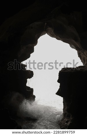 Waves from The Ocean with the Cave as the Picture Border for Framing Technique