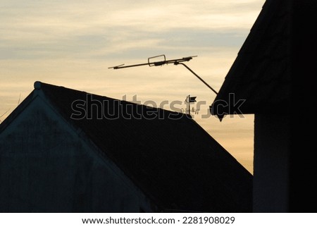 Silhouettes of house roofs with a weather vane in Bredelem, Germany