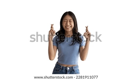 Young Asian woman making a symbolic gesture with fingers crossed showing good luck, White lie gesture, Fingers crossed, Woman doing hand sign on white background, Superstitious concept. Royalty-Free Stock Photo #2281911077