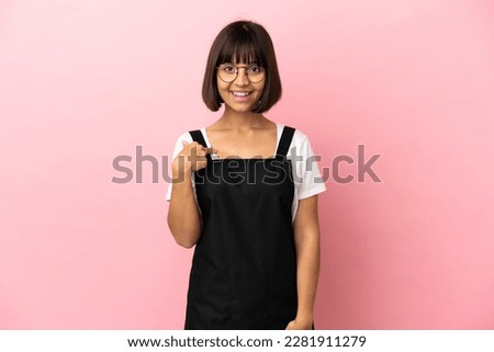 Restaurant waiter over isolated pink background with surprise facial expression