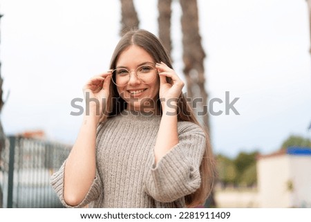Young pretty blonde woman With glasses with happy expression