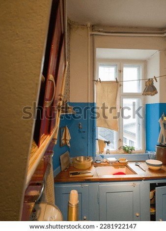 This kitchen in a 1960's Copenhagen workers apartment is a perfect example of old-world charm. From the classic top cupboard to the cluttered kitchen table, every detail tells a story of a bygone era. Royalty-Free Stock Photo #2281922147