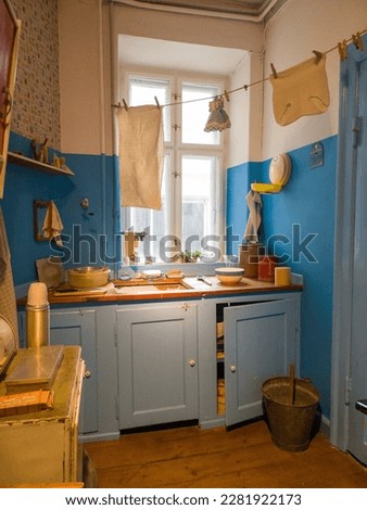 This photo captures a glimpse of life in a 1960's Copenhagen apartment kitchen. From the sink cluttered with dishes to the cloth drying line, it's a snapshot of a bygone era. Royalty-Free Stock Photo #2281922173