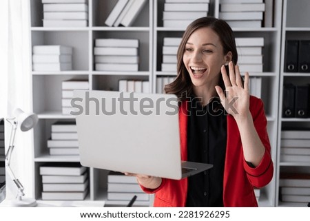 Young happy business woman having a video call with her team in the office room.