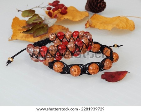 Colorful friendship bracelets and leafs. Colorful friendship bracelets on a white