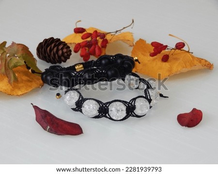 Colorful bracelets and leafs. Hippie bracelets on a white