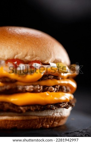 triple smashburger smash burger with cheddar  Royalty-Free Stock Photo #2281942997