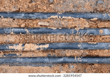 underground electric cable infrastructure installation. Construction site with A lot of communication Cables protected in tubes. electric and high-speed Internet Network cables are buried underground Royalty-Free Stock Photo #2281954547