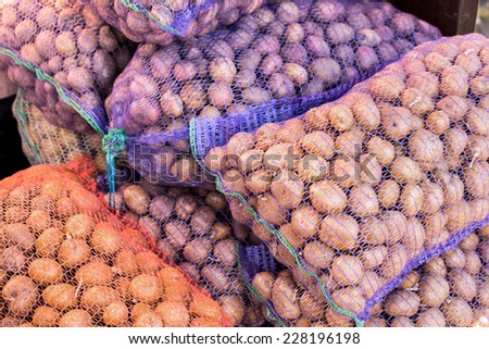Ripe potatoes in sack for background