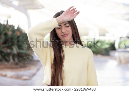 young pretty woman looking stressed, tired and frustrated, drying sweat off forehead, feeling hopeless and exhausted Royalty-Free Stock Photo #2281969483