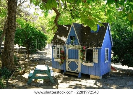 Tiny house in the garden for the kids to play Royalty-Free Stock Photo #2281972543
