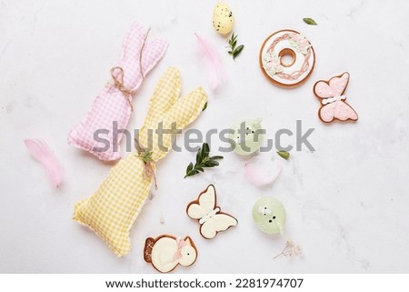 Easter traditional colorful cookies with handmade crafting bunny toys. Happy Easter background.