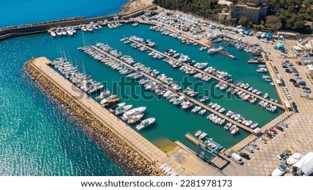 Aerial view of the marina and port of Santa Marinella, in the Metropolitan City of Rome, Italy. There are many boats moored at the harbour.
