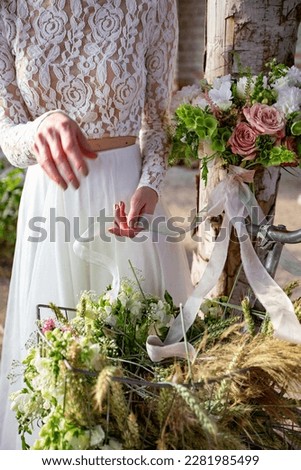 Wedding ceremony. Arch decorated with pink and white flowers and food standing in the forest, in the area of ​​the wedding ceremony