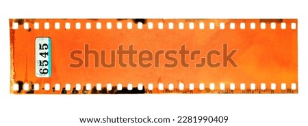 Start of 35mm negative filmstrip, first frame on white background, real scan of film material with cool scanning light interferences and developing smear marks on the film material. Royalty-Free Stock Photo #2281990409