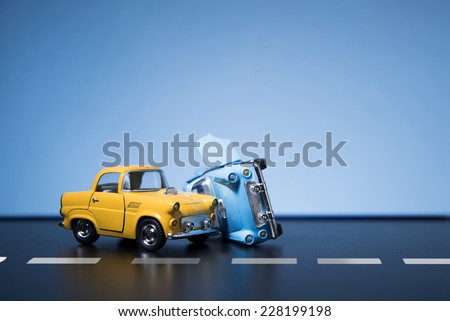 Classic fifties scale model toy cars accident on the road.