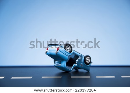 Classic fifties scale model toy car accident on the road. Royalty-Free Stock Photo #228199204