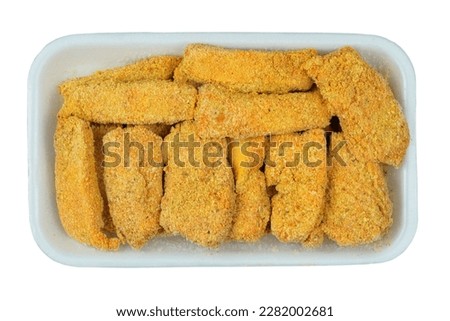 Frozen breaded orange fish fingers sticks texture in the white market fridge. Home cooking. Fast food.