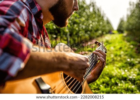 Man's hands playing acoustic guitar, close up. Acoustic guitars playing. Music concept. Guitars acoustic. Male musician playing guitar, music instrument.