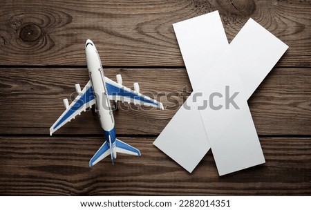 White blank air ticket mockups and air plane on wooden background. Travel concept. Template for design