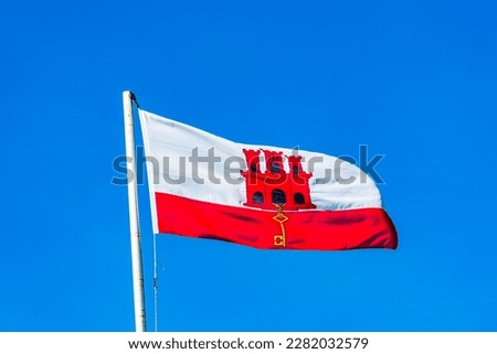 Gibraltar flag against blue sky