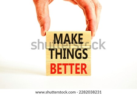Make things better symbol. Concept words Make things better on wooden block on a beautiful white table white background. Businessman hand. Business and make things better concept. Copy space.