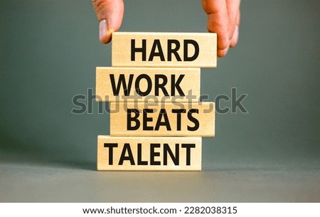 Hard work beats talent symbol. Concept words Hard work beats talent on woodenblock. Beautiful grey table grey background. Motivational business hard work beats talent concept. Copy space.