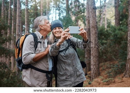 Elderly, couple take selfie and hiking in forest, happy people in nature and memory for social media post. Smile in picture, adventure and fitness, old man and woman are outdoor with active lifestyle