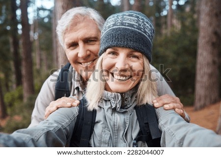 Senior couple, selfie and portrait, hiking in forest and happy people in nature and memory for social media post. Smile in picture, adventure and fitness outdoor, man and woman with active lifestyle