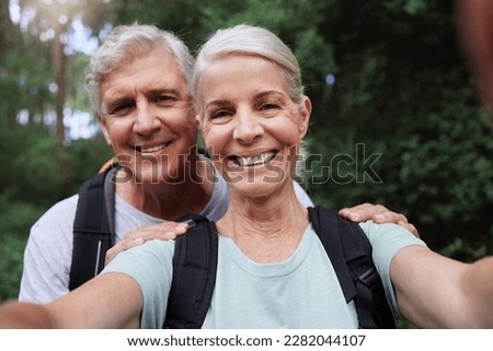 Selfie, hiking and portrait of senior couple with smile on adventure in forest, woods and mountain for exercise. Fitness, retirement and happy elderly man and woman take picture trekking for wellness