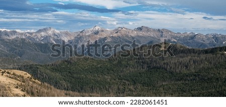 Panoramic view of several high mountain peaks in the San Juan Mountain Range can be viewed from Lobo Overlook, which is on top of the Continental Divide near Wolf Creek Pass, Colorado. Royalty-Free Stock Photo #2282061451