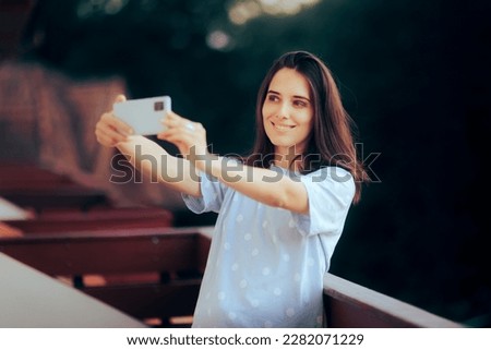 
Happy Woman Taking a Selfie in the Morning. Cheerful millennial girl photographing herself on vacation
