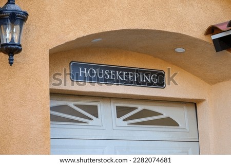 A single car garage is Housekeeping sign on top for utility vehicles and maintenance supplies and equipment storage.