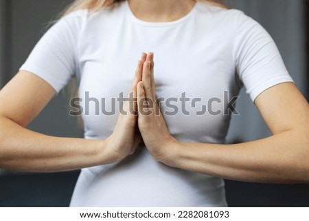 Close up view of the pregnant woman meditating in yoga pose. Pregnancy yoga and fitness concept